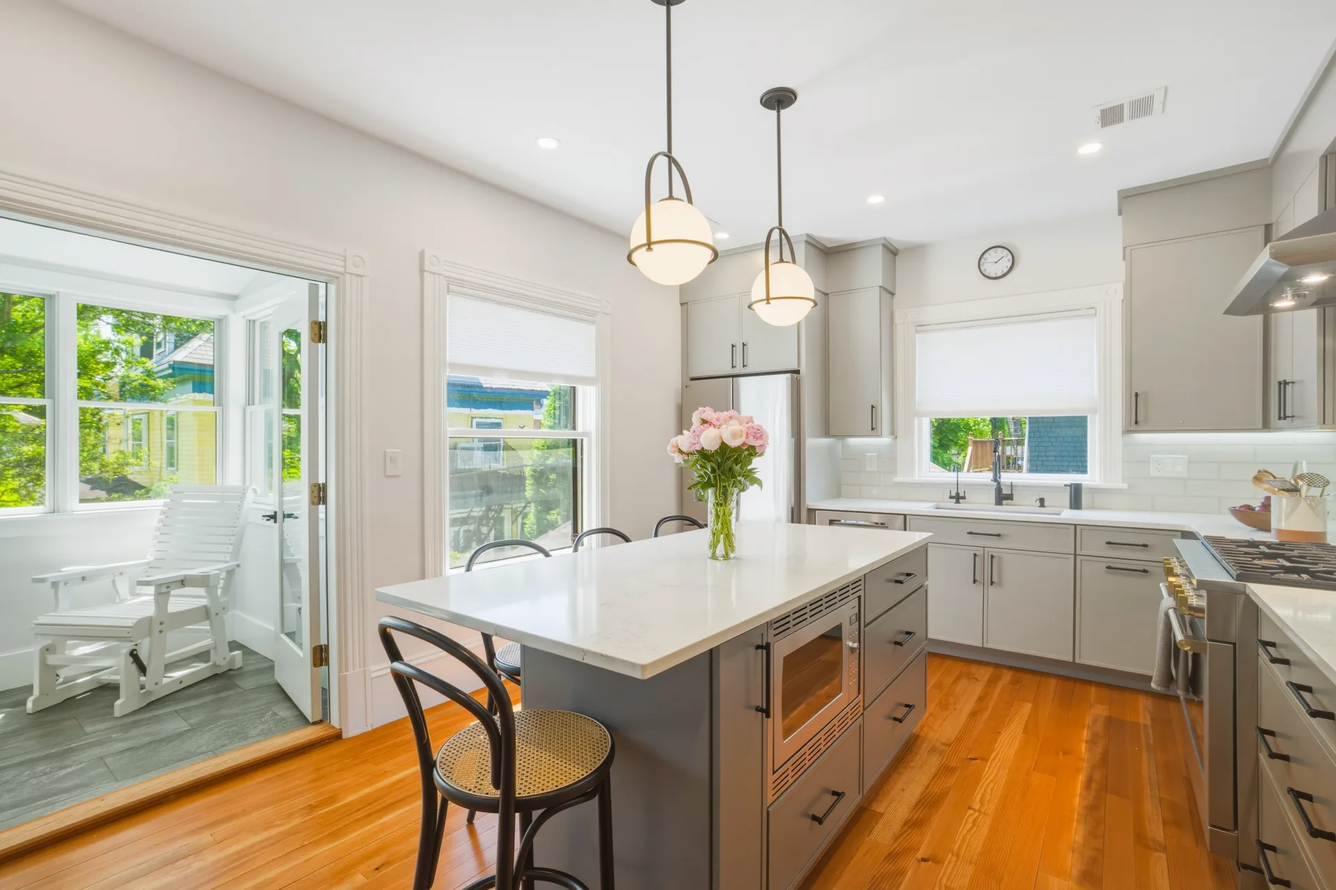 Bright kitchen renovation with a large island and gray cabinetry