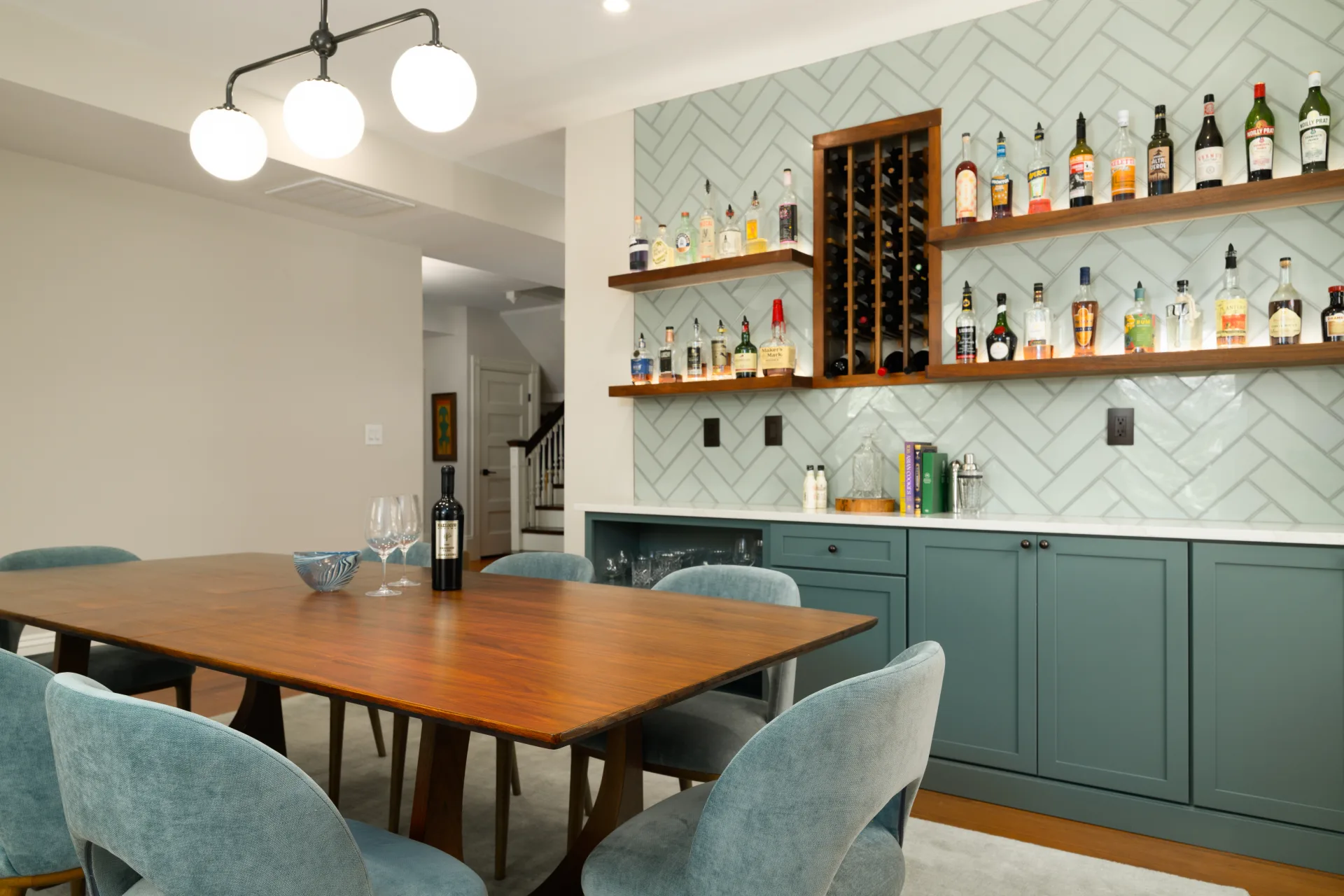 Custom dining room bar with teal cabinetry and wine storage