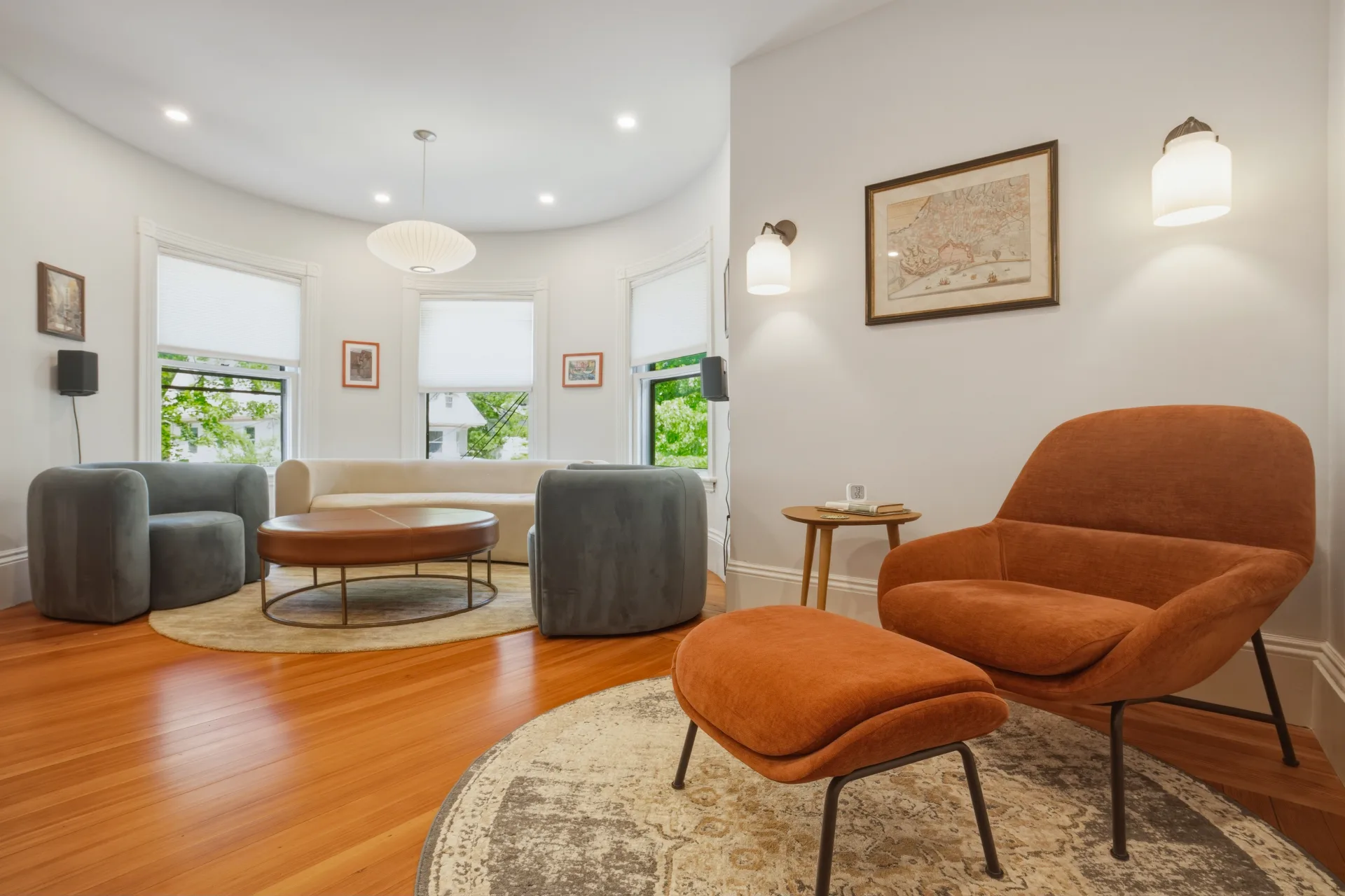 Renovated living room with bay windows and modern lighting